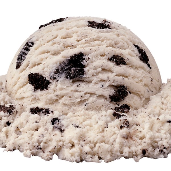 A scoop of Kwality Norwood's cookies and cream ice cream with visible dark cookie pieces.